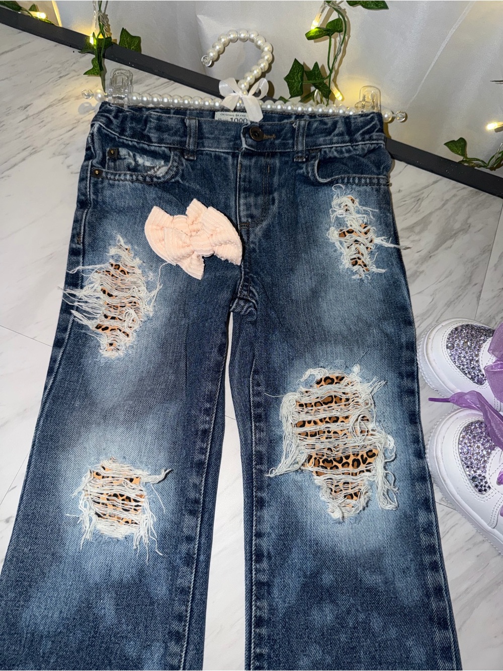 Hand distressed jeans with leopard peekaboo and “Blessed” patch